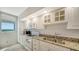 Well-equipped kitchen featuring white cabinets and granite at 1055 Gulf Of Mexico Dr # 504, Longboat Key, FL 34228