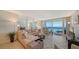 Bright living room with L-shaped sofa and ocean view at 1055 Gulf Of Mexico Dr # 504, Longboat Key, FL 34228