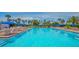 Relaxing pool area with ample seating and blue umbrellas at 1055 Gulf Of Mexico Dr # 504, Longboat Key, FL 34228
