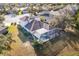 An elevated view of a home's backyard, including screened-in pool and spa with surrounding patio at 12342 Lavender Loop, Bradenton, FL 34212