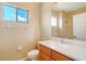 Simple bathroom with wood vanity, white countertop, and tiled flooring at 12342 Lavender Loop, Bradenton, FL 34212