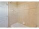 Bathroom with tiled walls surrounding bathtub and shower combination at 12342 Lavender Loop, Bradenton, FL 34212