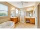 Large bathroom with dual sinks, a soaking tub, shower, and tile flooring at 12342 Lavender Loop, Bradenton, FL 34212