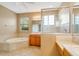Spacious bathroom featuring a soaking tub, separate shower, dual vanities, and tile flooring at 12342 Lavender Loop, Bradenton, FL 34212