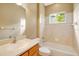 Bathroom with tiled shower, single vanity, and neutral decor at 12342 Lavender Loop, Bradenton, FL 34212