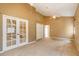 Spacious bedroom with carpeted flooring, French doors, and a large closet at 12342 Lavender Loop, Bradenton, FL 34212