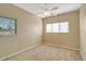 Spacious bedroom with carpeted flooring, ceiling fan, and two large windows with blinds at 12342 Lavender Loop, Bradenton, FL 34212