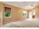 Spacious bedroom with carpeted floors, ceiling fan, and windows at 12342 Lavender Loop, Bradenton, FL 34212
