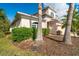 Front exterior of home framed by palm trees and lush greenery at 12342 Lavender Loop, Bradenton, FL 34212