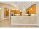 Kitchen with wood cabinetry, stainless steel appliances, and a breakfast bar at 12342 Lavender Loop, Bradenton, FL 34212