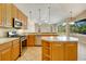 Bright kitchen with ample counter space, stainless steel appliances, and wood cabinetry at 12342 Lavender Loop, Bradenton, FL 34212