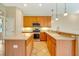 Kitchen island with stainless steel appliances and wood cabinetry at 12342 Lavender Loop, Bradenton, FL 34212