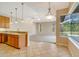 Kitchen with a breakfast bar, overlooking the living area with large windows at 12342 Lavender Loop, Bradenton, FL 34212