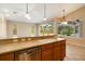 Kitchen with double sink, dishwasher, and view of the backyard at 12342 Lavender Loop, Bradenton, FL 34212