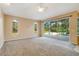 Spacious living room with sliding glass doors leading to a pool and backyard at 12342 Lavender Loop, Bradenton, FL 34212