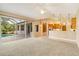 Open living room and kitchen area with vaulted ceiling, carpeted flooring, and views to the pool at 12342 Lavender Loop, Bradenton, FL 34212
