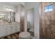Contemporary bathroom boasts a walk-in shower, dual vanities, and modern fixtures at 1256 Napoleon Rd, North Port, FL 34288