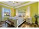 Inviting bedroom with green walls, white furniture, and large windows at 1256 Napoleon Rd, North Port, FL 34288