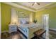 Bedroom with green walls, white furnishings, and a view to the bathroom at 1256 Napoleon Rd, North Port, FL 34288