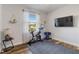 A bedroom transformed into a home gym, complete with an exercise bike and weights at 1256 Napoleon Rd, North Port, FL 34288
