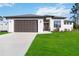 Charming single-story home with a two-car garage and landscaped front yard at 1256 Napoleon Rd, North Port, FL 34288