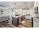 Modern kitchen with an island, stainless steel appliances, and wood-look flooring at 1256 Napoleon Rd, North Port, FL 34288
