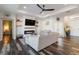 Cozy living room with a fireplace, built-in shelves, and wood-look floors at 1256 Napoleon Rd, North Port, FL 34288