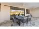Covered patio with outdoor dining set and ceiling fans at 1256 Napoleon Rd, North Port, FL 34288