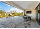 Spacious covered patio with an outdoor dining area, lounge chairs, and a pool at 1256 Napoleon Rd, North Port, FL 34288