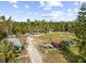 Aerial view of waterfront property with boat storage and lush landscaping at 1285 & 1289 Hagle Park Rd, Bradenton, FL 34212