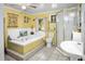 Bathroom with yellow walls, a large tub, and a walk-in shower at 1285 & 1289 Hagle Park Rd, Bradenton, FL 34212