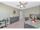 bedroom with gray dresser, ceiling fan, and playful decor at 15511 Islandwalk Ave, Bradenton, FL 34211