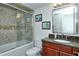 Bathroom with tub shower, granite vanity, and tiled walls at 1700 Cove Ii Pl # 311, Sarasota, FL 34242