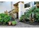 Ground level entrance with stairs and lush landscaping at 1700 Cove Ii Pl # 311, Sarasota, FL 34242
