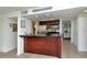 Kitchen with dark wood cabinets and a breakfast bar at 1700 Cove Ii Pl # 311, Sarasota, FL 34242