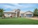 Charming coastal home with a welcoming front porch and lush landscaping at 17942 Palmiste Dr, Bradenton, FL 34202