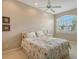 Bedroom with two twin beds, large window, and ceiling fan at 1901 Harbour Links Cir # 1, Longboat Key, FL 34228