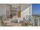 Outdoor grill and seating area on the balcony overlooking water at 2050 Benjamin Franklin Dr # B603, Sarasota, FL 34236