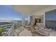 Balcony dining set and lounge chair overlooking the beach at 2050 Benjamin Franklin Dr # B603, Sarasota, FL 34236