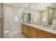 Elegant bathroom with double vanity, large mirror, and walk-in shower at 2050 Benjamin Franklin Dr # B603, Sarasota, FL 34236