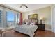 Bedroom with wood floors, balcony access, and an ocean view at 2050 Benjamin Franklin Dr # B603, Sarasota, FL 34236