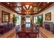 Formal dining room with long table, wood ceiling, fireplace, and large windows at 2050 Benjamin Franklin Dr # B603, Sarasota, FL 34236