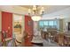 Dining room with a dark wood table and chairs and a view into the living room at 2050 Benjamin Franklin Dr # B603, Sarasota, FL 34236