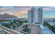 View from the building overlooking a courtyard, palm trees, and the water at 2050 Benjamin Franklin Dr # B603, Sarasota, FL 34236