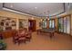 Game room with pool table, card table, wet bar, and abundant natural light at 2050 Benjamin Franklin Dr # B603, Sarasota, FL 34236