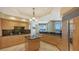 Spacious kitchen with an island, dark granite countertops, light wood cabinets, and stainless steel appliances at 2050 Benjamin Franklin Dr # B603, Sarasota, FL 34236