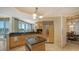 Kitchen with granite countertops, an island, stainless steel appliances, and a view of the dining area at 2050 Benjamin Franklin Dr # B603, Sarasota, FL 34236