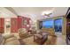 Comfortable living area with plush seating, an accent wall, and sliding glass doors leading to a balcony at 2050 Benjamin Franklin Dr # B603, Sarasota, FL 34236