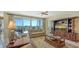 Living room with leather sofa, entertainment center, and balcony access at 2050 Benjamin Franklin Dr # B603, Sarasota, FL 34236