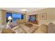 Inviting living room with leather furniture, a large entertainment center, and access to a balcony at 2050 Benjamin Franklin Dr # B603, Sarasota, FL 34236